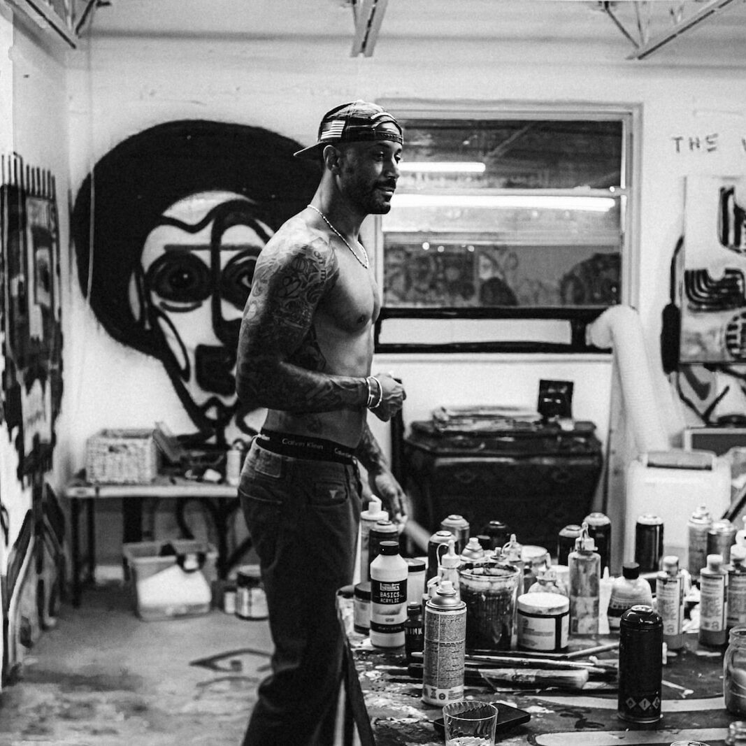 a man standing in a room with lots of bottles