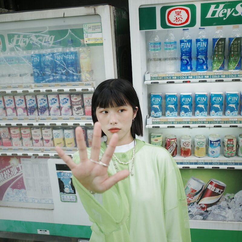 a woman standing in front of a vending machine
